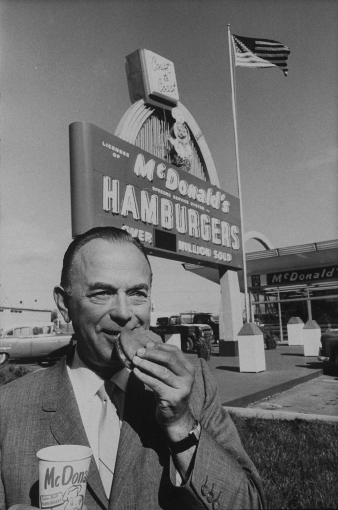 Portrait of McDonald's owner Ray Kroc eating hamburger in front of Neon sign outside restaurant (Photo by Art Shay/The LIFE Images Collection/Getty Images)